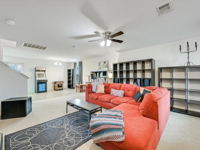 living room with ceiling fan with notable chandelier