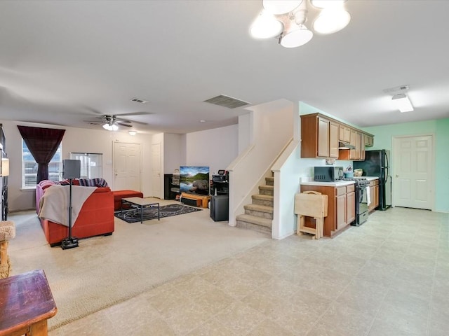 living room with light carpet and ceiling fan with notable chandelier