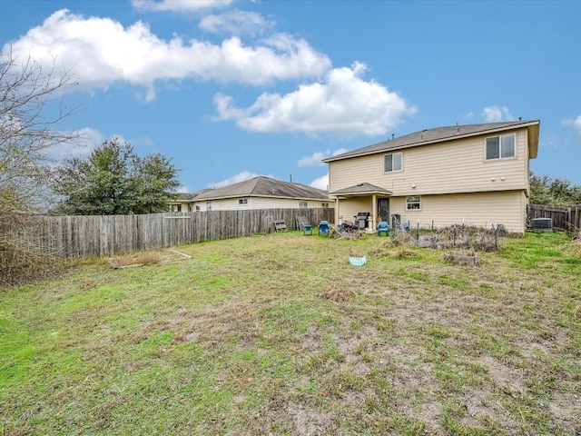 rear view of property with a lawn and cooling unit