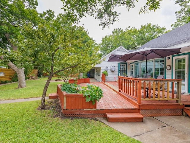 wooden terrace featuring a lawn