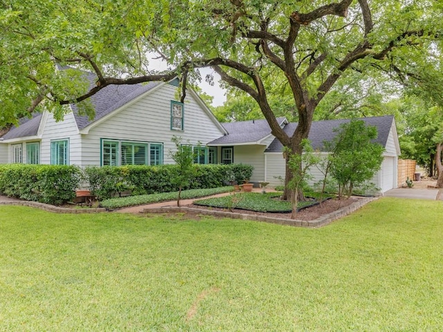 view of front of home featuring a garage and a front lawn