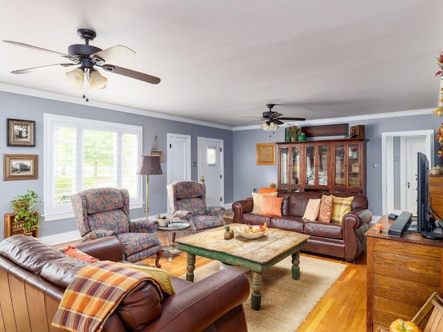 living room featuring light hardwood / wood-style floors, ornamental molding, and french doors