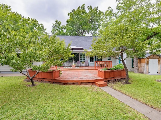 back of property featuring a storage shed, a yard, a gazebo, and a deck