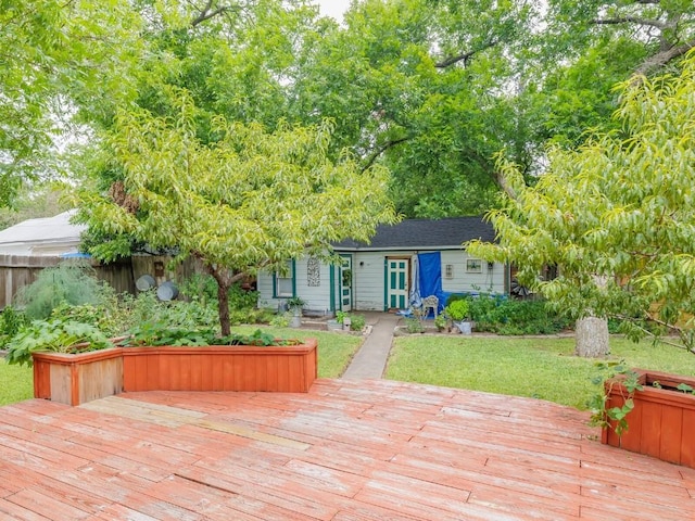 wooden terrace featuring a lawn