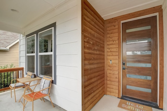 view of exterior entry featuring a porch