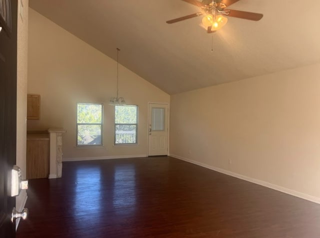 interior space with dark hardwood / wood-style floors, ceiling fan with notable chandelier, and high vaulted ceiling