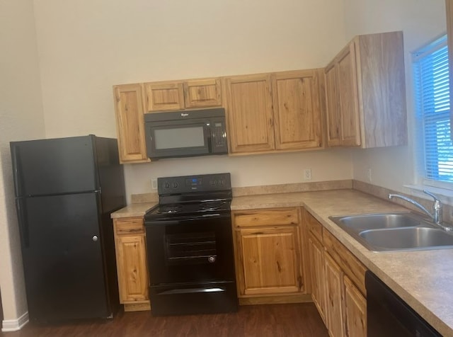 kitchen featuring light brown cabinetry, dark hardwood / wood-style flooring, sink, and black appliances