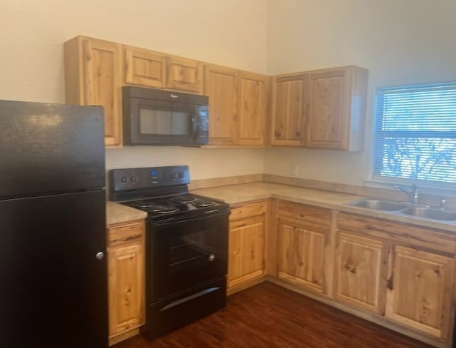 kitchen featuring black appliances, sink, light brown cabinetry, and dark wood-type flooring