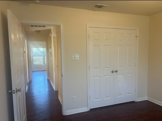 corridor featuring dark hardwood / wood-style flooring