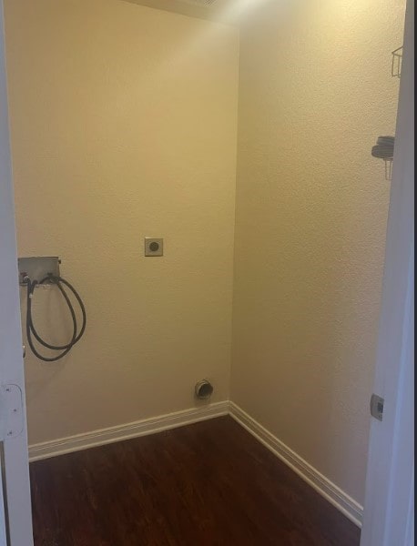 laundry room featuring hookup for a washing machine, electric dryer hookup, and dark wood-type flooring