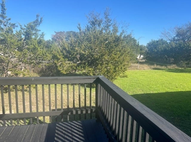 wooden terrace featuring a lawn