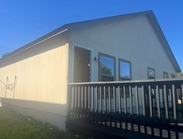 view of side of home featuring a wooden deck