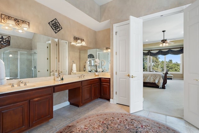 bathroom with vanity, a shower with door, and ceiling fan