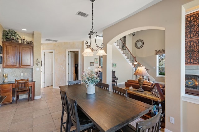 dining room featuring a chandelier and light tile patterned flooring