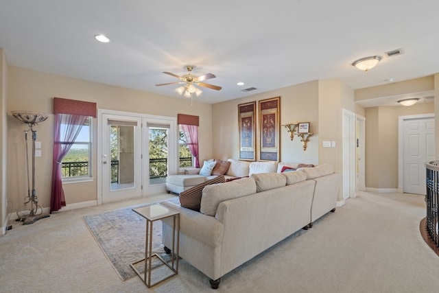 living room featuring ceiling fan and light colored carpet