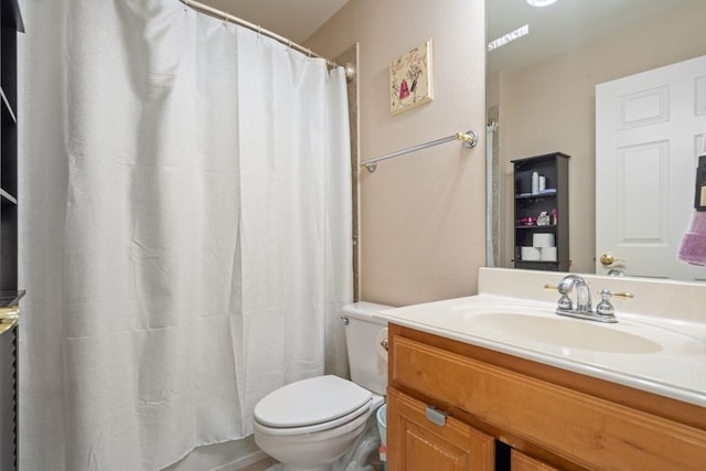 bathroom featuring vanity, toilet, and walk in shower