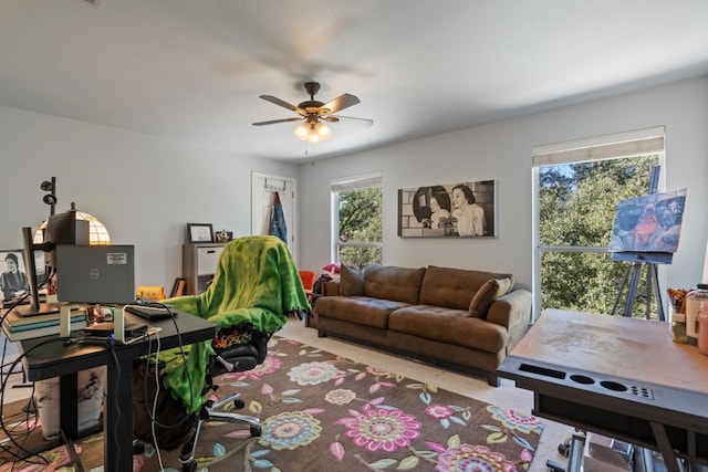 carpeted living room with ceiling fan