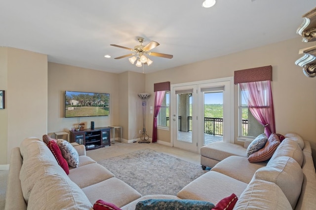 living room with ceiling fan and light carpet