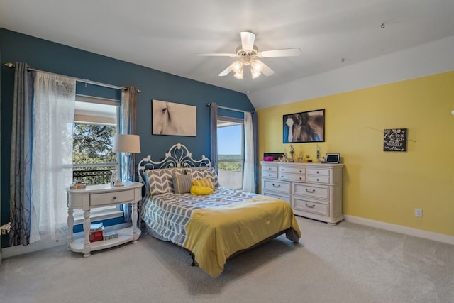 carpeted bedroom featuring ceiling fan and vaulted ceiling