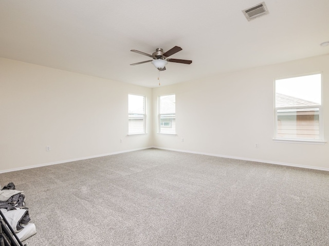 spare room featuring carpet flooring and ceiling fan