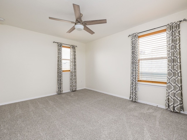 carpeted empty room featuring ceiling fan