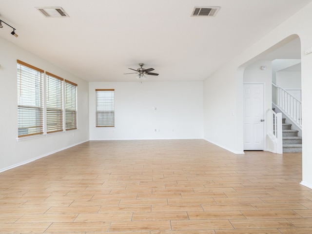 unfurnished room featuring track lighting and ceiling fan