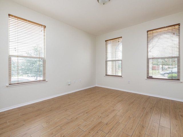 spare room featuring light hardwood / wood-style flooring