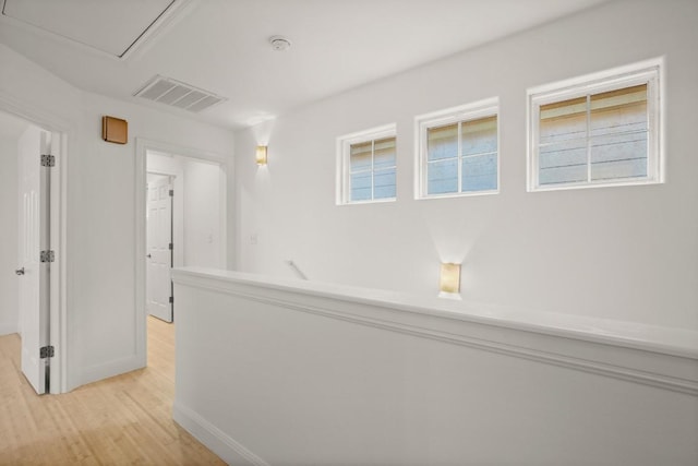 hallway with light hardwood / wood-style flooring