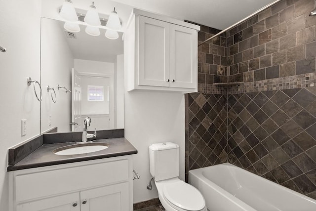 full bathroom with vanity, toilet, and tiled shower / bath combo