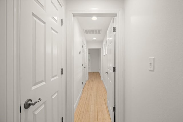 corridor with light wood-type flooring