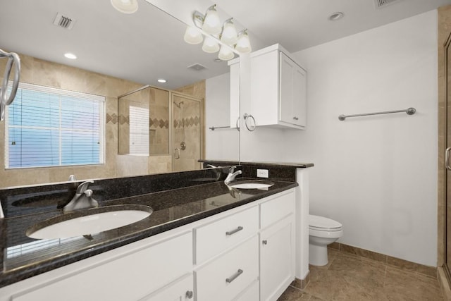 bathroom featuring tile patterned floors, vanity, toilet, and an enclosed shower