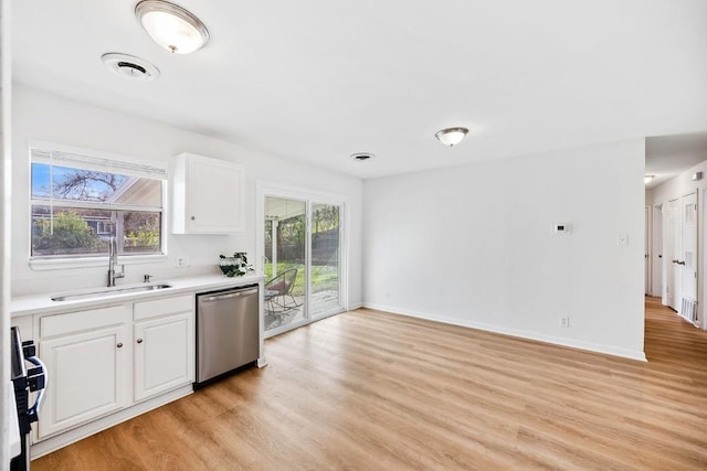 kitchen featuring range, dishwasher, white cabinets, and sink