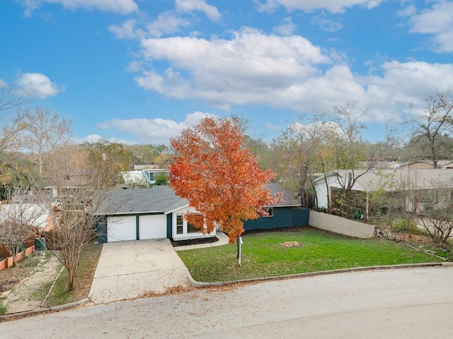 view of front of home featuring a garage and a front yard