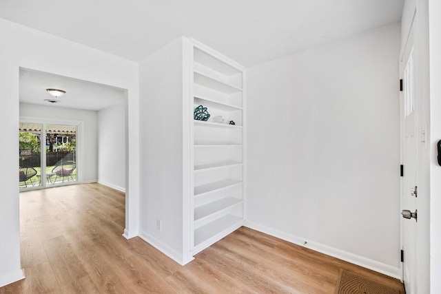 hallway with light hardwood / wood-style flooring