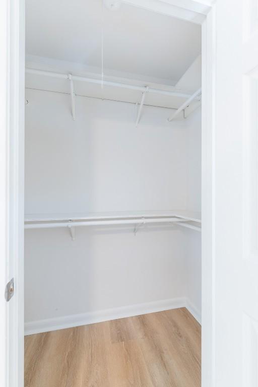 walk in closet featuring hardwood / wood-style floors