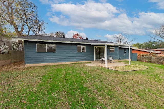 rear view of property with a yard and a patio