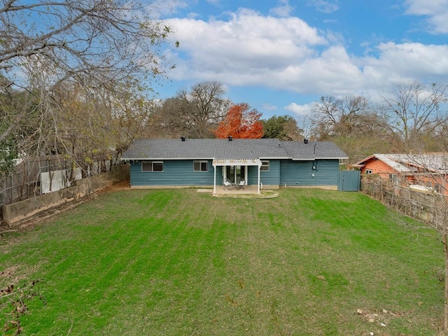 rear view of house with a patio area and a yard