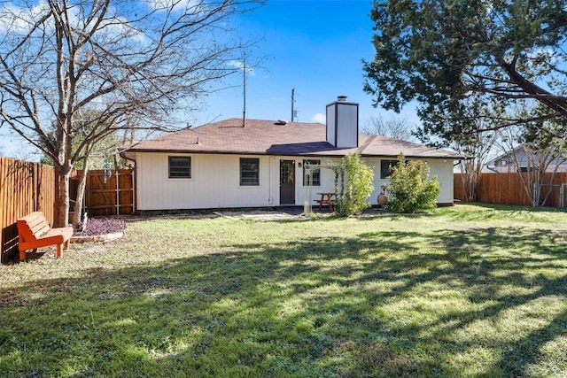 rear view of house featuring a yard