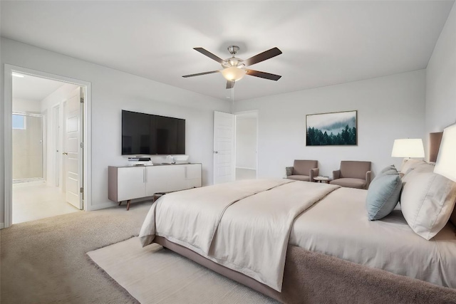 carpeted bedroom with ensuite bath and ceiling fan