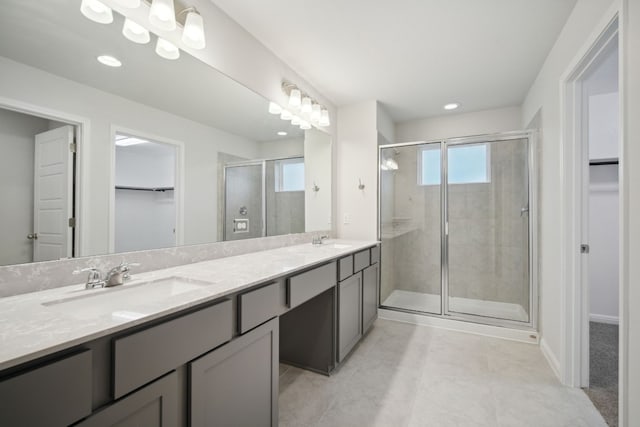 bathroom featuring tile patterned floors, vanity, and a shower with shower door