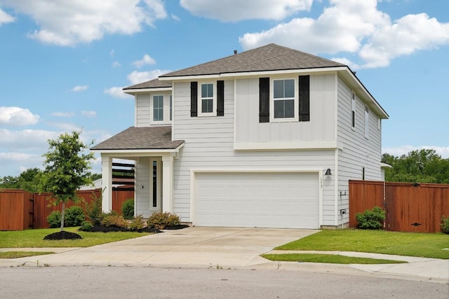 view of front of house with a front lawn and a garage