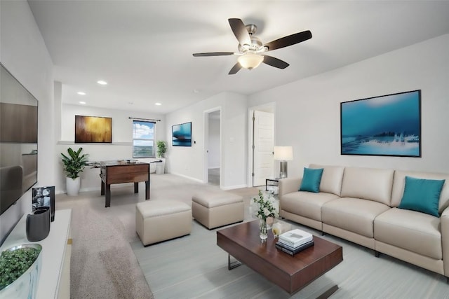 carpeted living room featuring ceiling fan