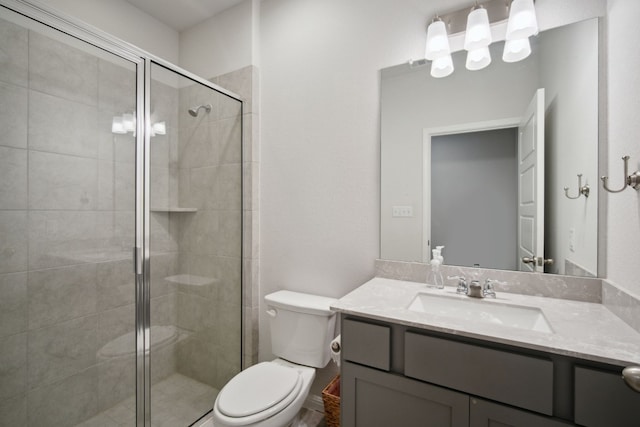 bathroom with vanity, toilet, and a shower with shower door