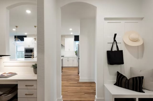 mudroom with light hardwood / wood-style flooring and a healthy amount of sunlight