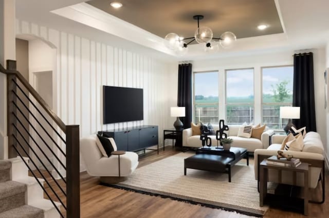 living room featuring a raised ceiling and wood-type flooring