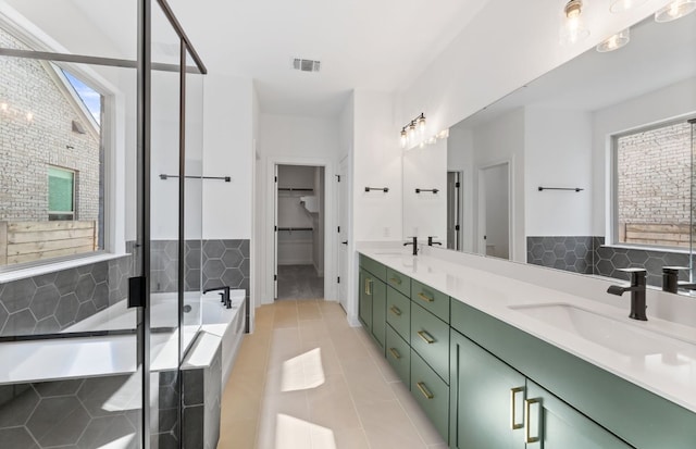 3353 Vestland Fjord St, Leander, TX 78641 - full bathroom with a sink, tile patterned flooring, double vanity, visible vents, and a stall shower