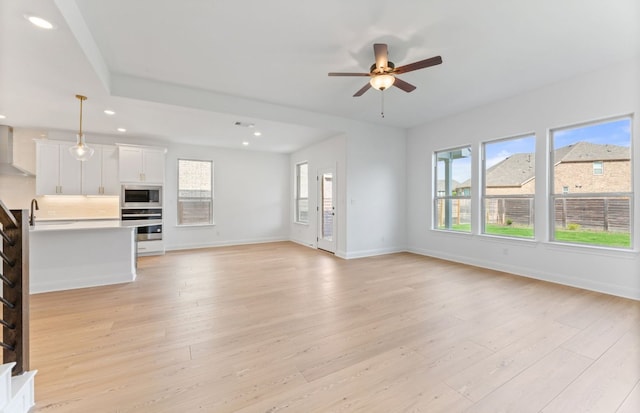 3353 Vestland Fjord St, Leander, TX 78641 - unfurnished living room featuring stairs, baseboards, recessed lighting, light wood-type flooring, and a ceiling fan