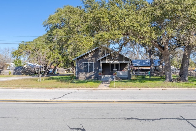 view of front of home featuring a front yard and a porch