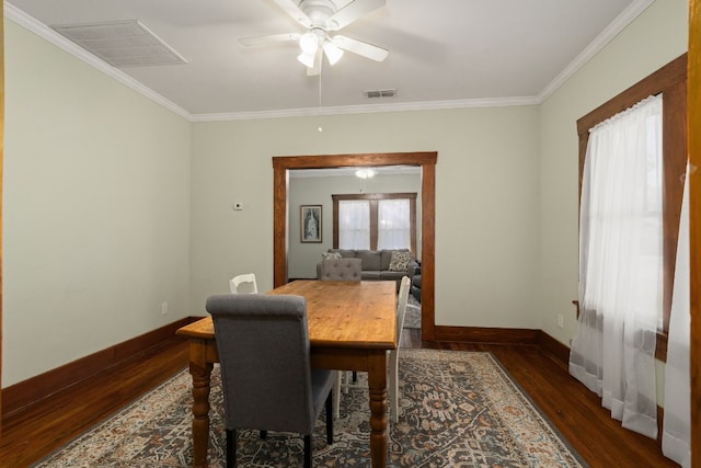 dining room with dark hardwood / wood-style flooring, ceiling fan, and crown molding