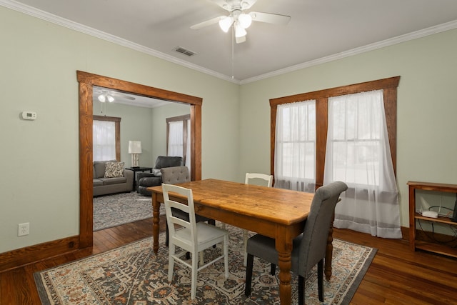 dining area with dark hardwood / wood-style flooring, ceiling fan, and crown molding